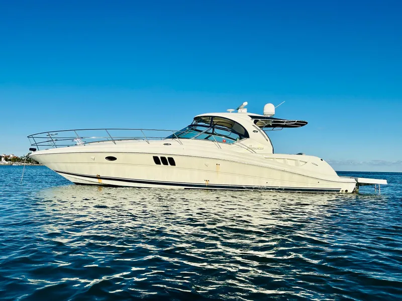 Slide: The Image of 2007 Sea Ray 44 Sundancer yacht on calm water under clear blue sky. - 4