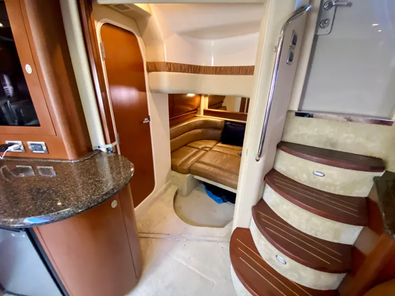 Slide: The Image of 2007 Sea Ray 44 Sundancer interior with stairs, seating area, and kitchenette. - 41
