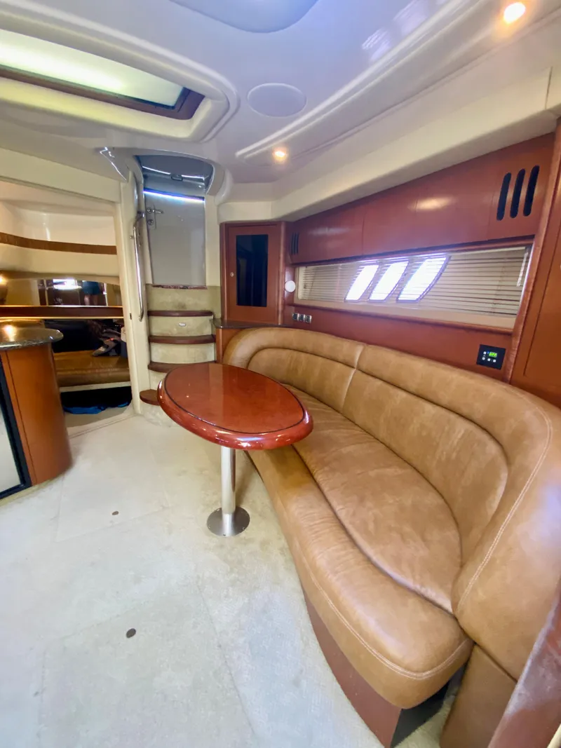 Slide: The Image of Interior of 2007 Sea Ray 44 Sundancer yacht with leather seating and wooden table. - 49