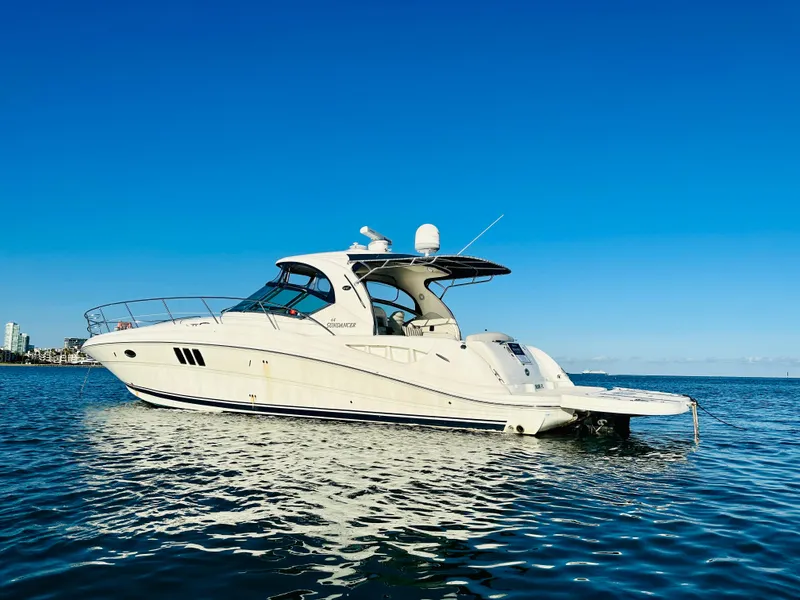 Slide: The Image of 2007 Sea Ray 44 Sundancer yacht on calm water under clear blue sky. - 5