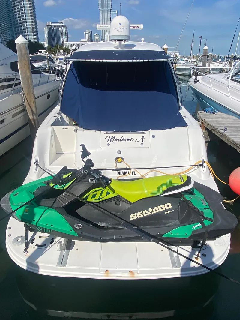 Slide: The Image of 2007 Sea Ray 44 Sundancer yacht with a Sea-Doo jet ski docked in Miami. - 7