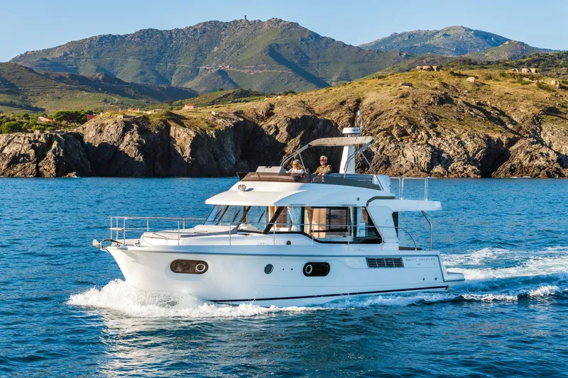 Slide: The Image of 2025 Beneteau Swift Trawler 41 Fly cruising near rocky coastline. - 19