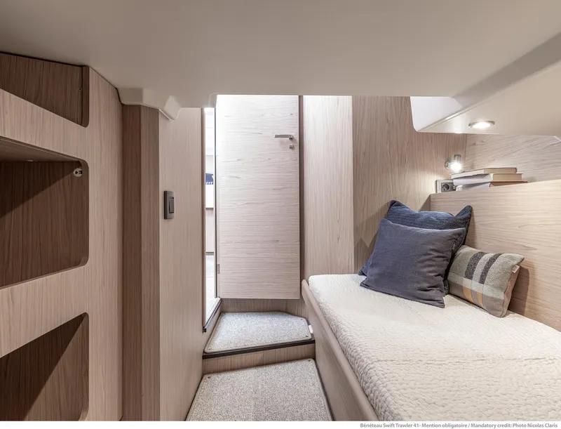 Slide: The Image of 2025 Beneteau Swift Trawler 41 Fly cabin interior with cozy bedding and modern design. - 9