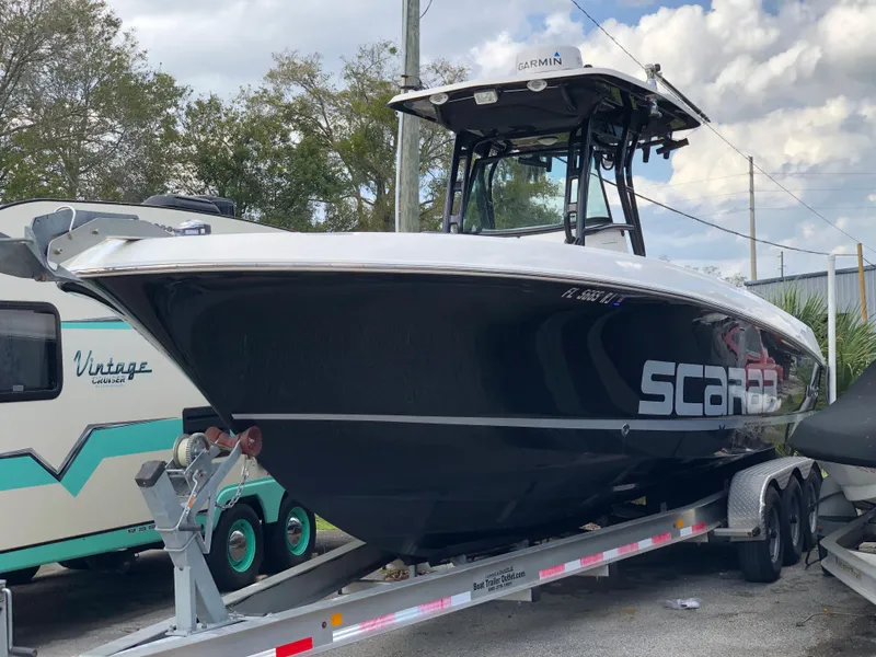 The Image of 2016 Wellcraft 30 Scarab Offshore Tournament boat on a trailer. - 1