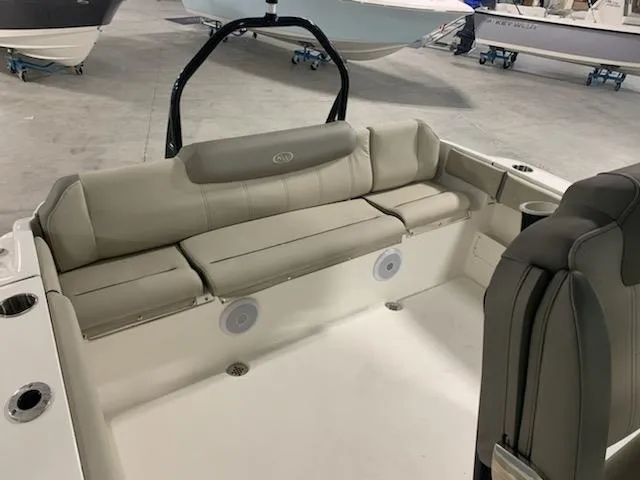 Slide: The Image of 2024 Key West 239 FS boat interior with cushioned seating and cup holders. - 2
