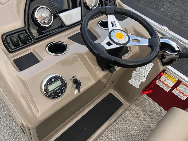 Slide: The Image of 2023 Ranger 200C boat dashboard with steering wheel and control panel. - 10