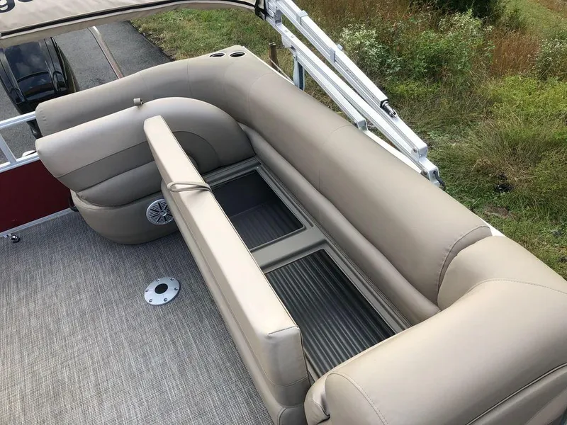 Slide: The Image of 2023 Ranger 200C boat interior with beige seating and storage compartments. - 11