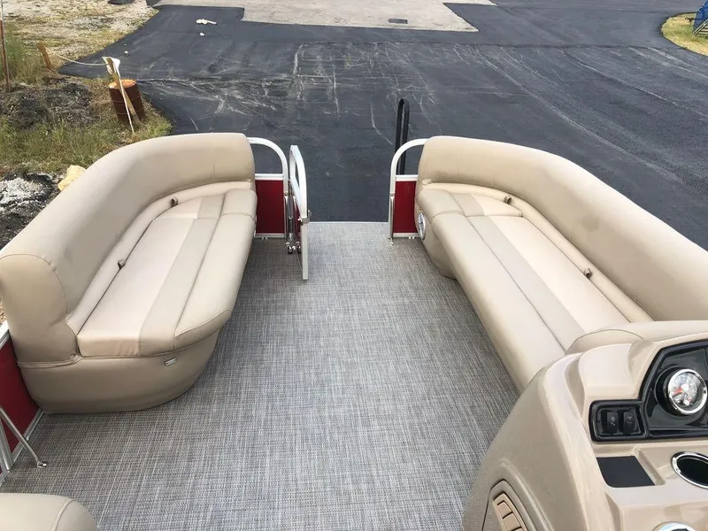 Slide: The Image of 2023 Ranger 200C boat interior with beige seating and gray flooring. - 12