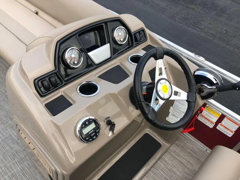 Slide: The Image of 2023 Ranger 200C boat dashboard with steering wheel and instrument panel. - 13