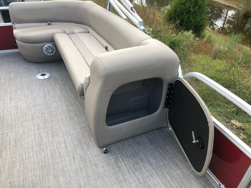 Slide: The Image of 2023 Ranger 200C pontoon boat with beige seating and storage compartment. - 17