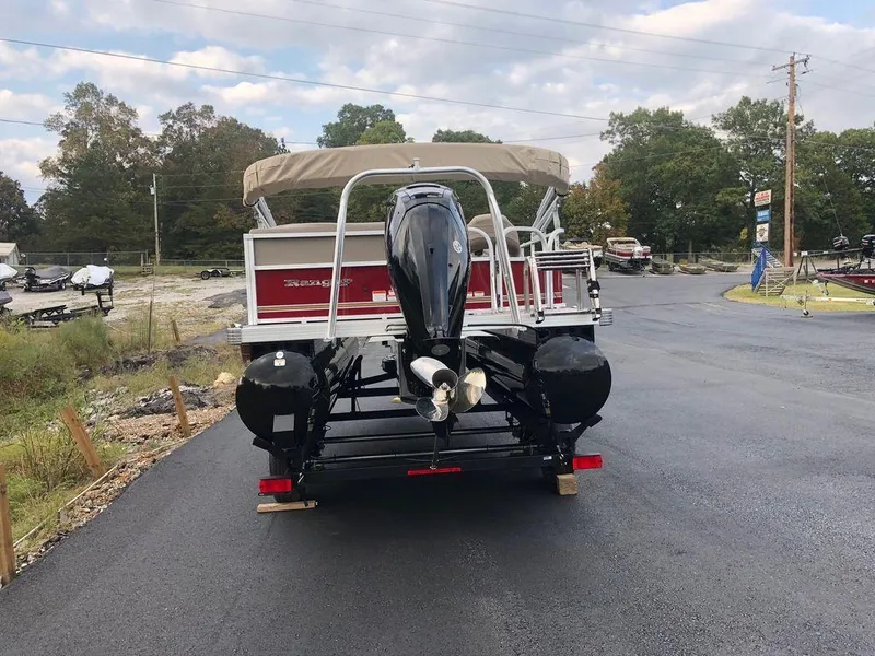Slide: The Image of 2023 Ranger 200C pontoon boat with outboard motor on paved road. - 6