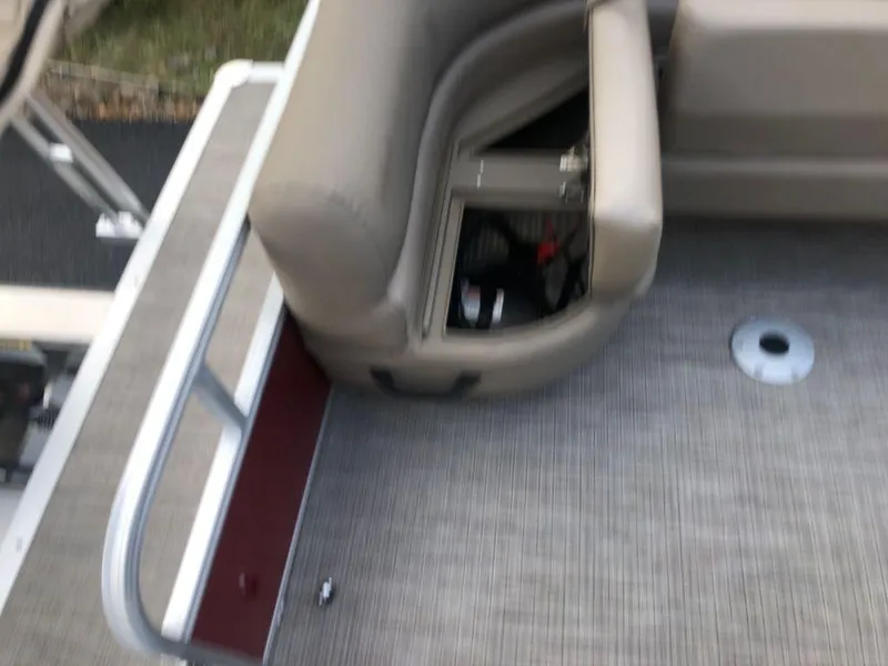 Slide: The Image of 2023 Ranger 200C boat interior with beige seating and storage compartment. - 8