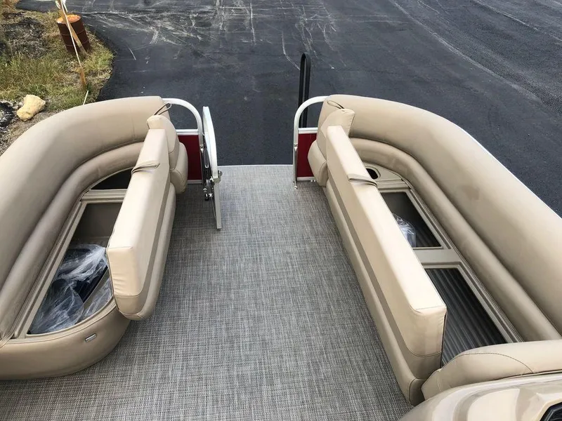 Slide: The Image of 2023 Ranger 200C boat interior with beige seating and gray flooring. - 9