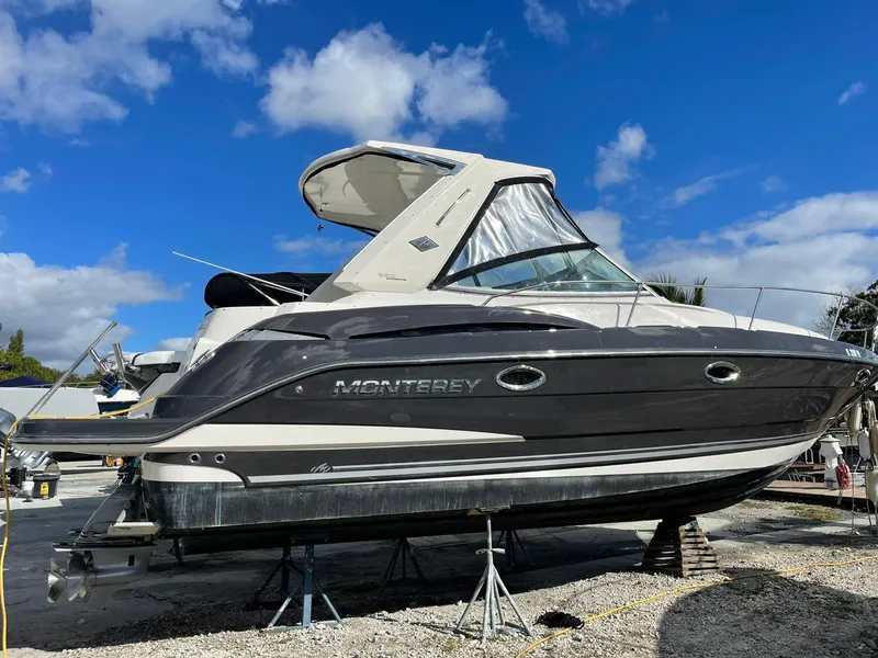 Slide: The Image of 2014 Monterey 320 Sport Yacht on dry dock under a clear blue sky. - 0