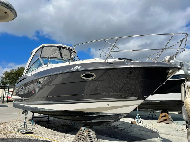 Slide: The Image of 2014 Monterey 320 Sport Yacht on dry dock under a partly cloudy sky. - 1
