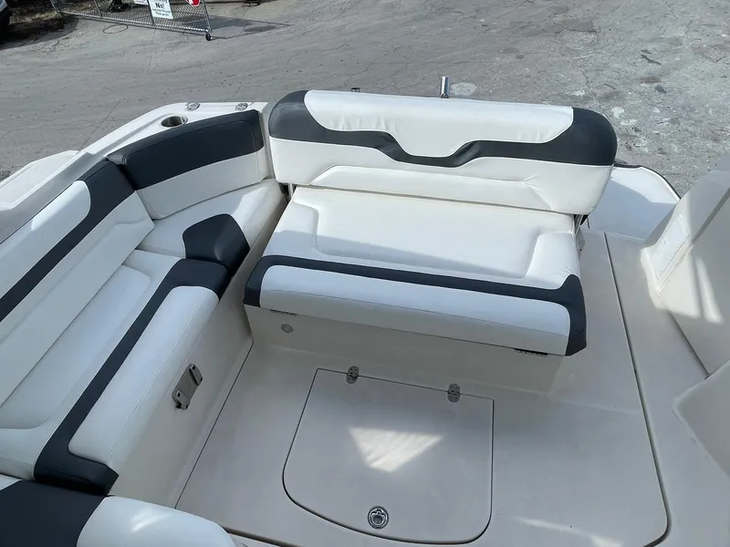 Slide: The Image of 2014 Monterey 320 Sport Yacht interior seating area with white and black upholstery. - 15