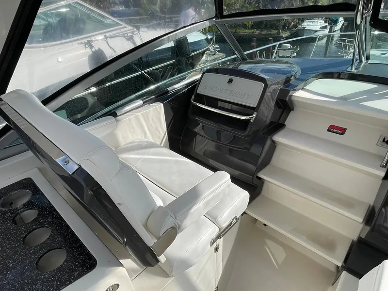 Slide: The Image of Cockpit view of 2014 Monterey 320 Sport Yacht with white seating and modern dashboard. - 17