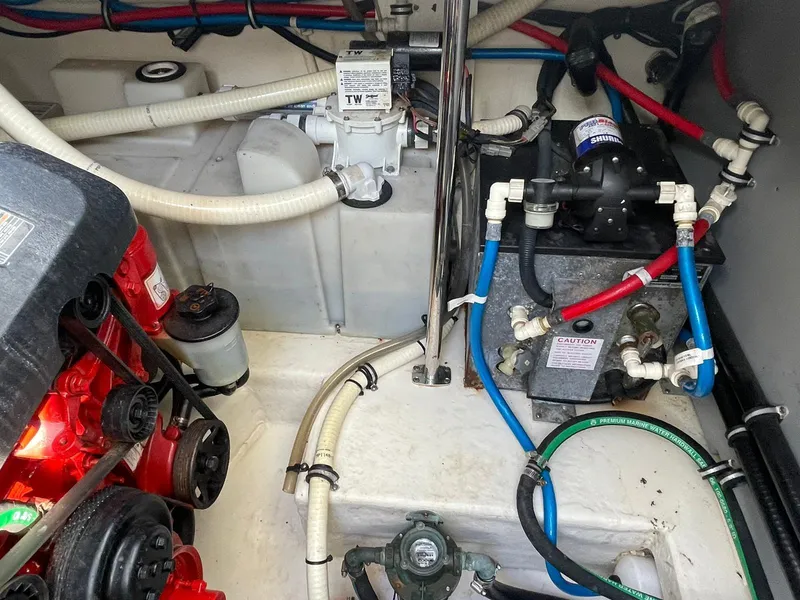 Slide: The Image of Engine compartment of a 2014 Monterey 320 Sport Yacht with various mechanical components. - 18