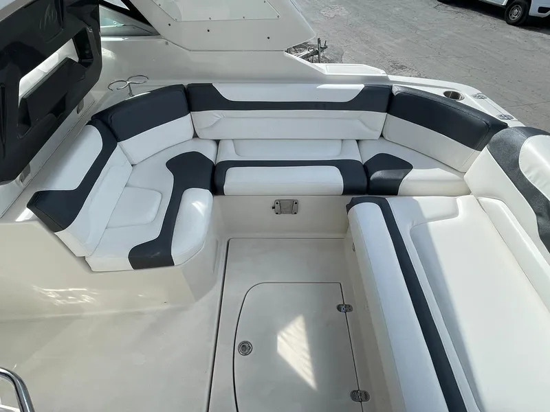 Slide: The Image of 2014 Monterey 320 Sport Yacht interior seating area with white and black upholstery. - 19