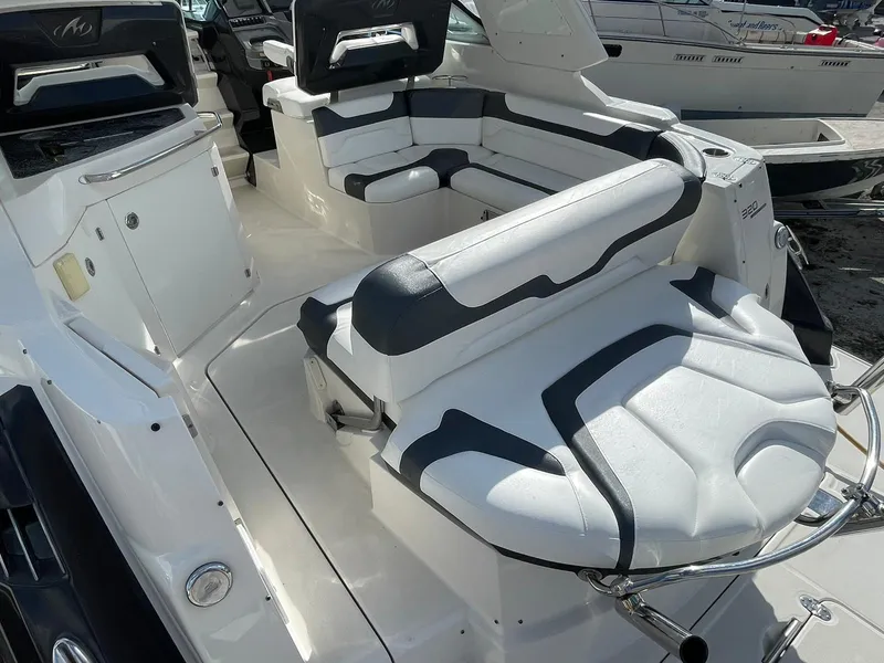 Slide: The Image of 2014 Monterey 320 Sport Yacht interior with white and black seating. - 21
