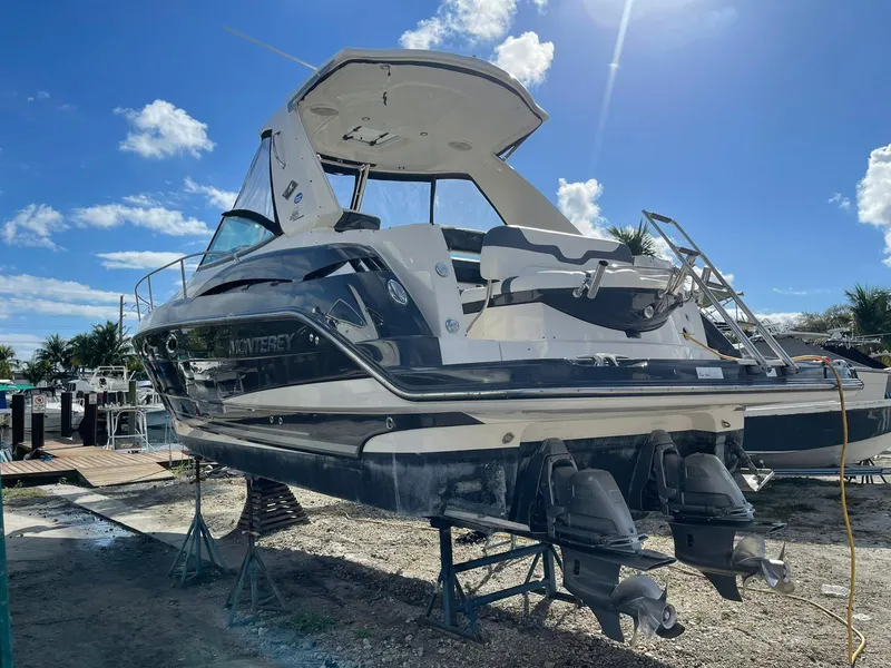 Slide: The Image of 2014 Monterey 320 Sport Yacht on stands, rear view, sunny day. - 5