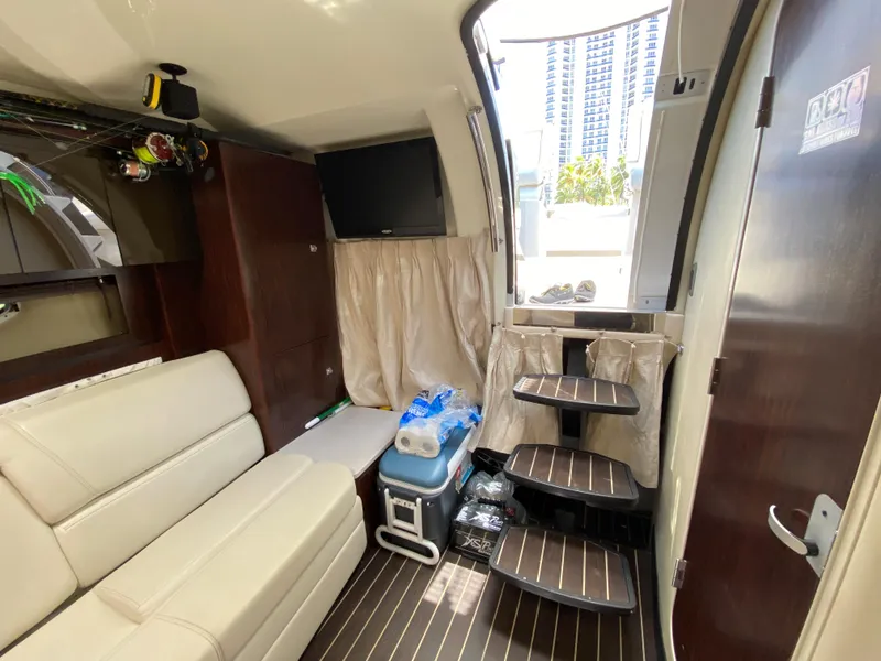 Slide: The Image of Interior of 2014 Monterey 320 Sport Yacht with seating, TV, and steps to deck. - 9