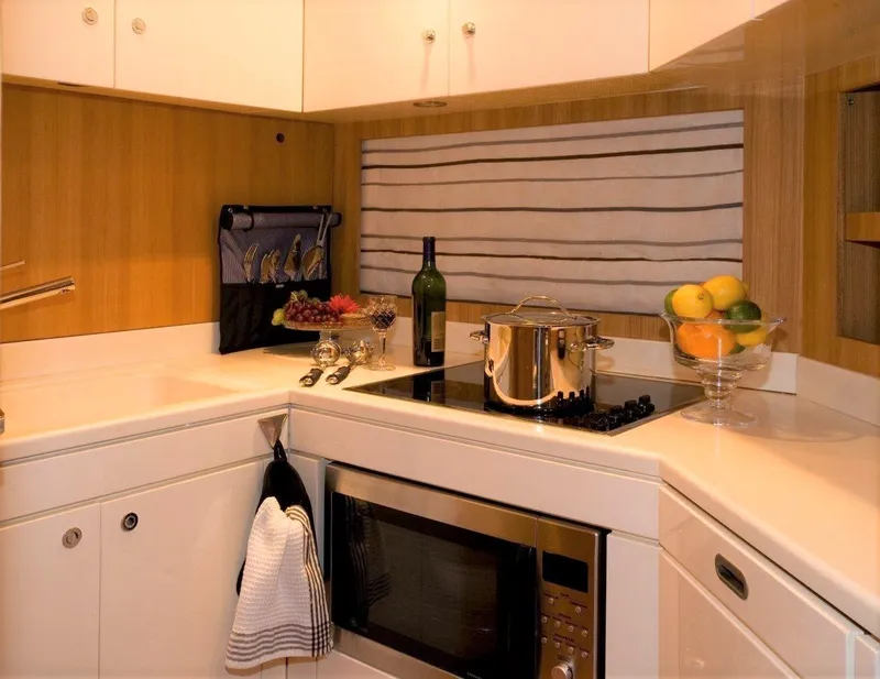 Slide: The Image of Modern kitchen in a 2004 Riva Splendida yacht with stove, microwave, and fruit bowl. - 10
