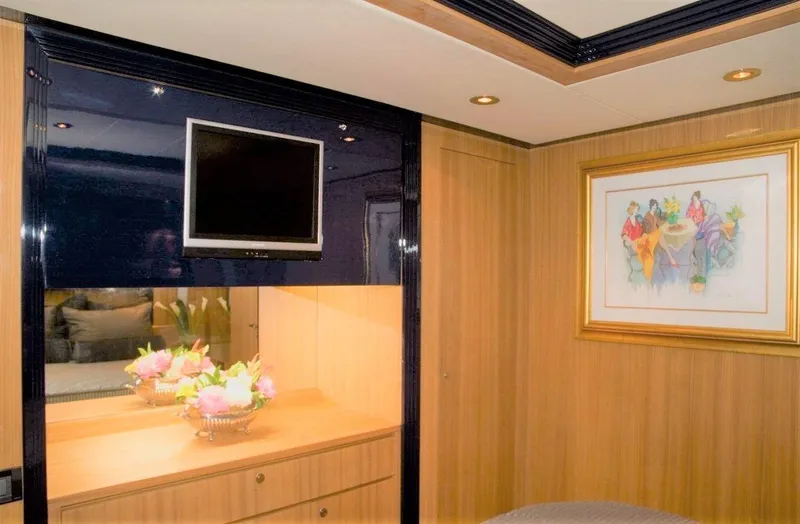 Slide: The Image of Luxurious interior of 2004 Riva Splendida yacht with TV, artwork, and floral arrangement. - 14