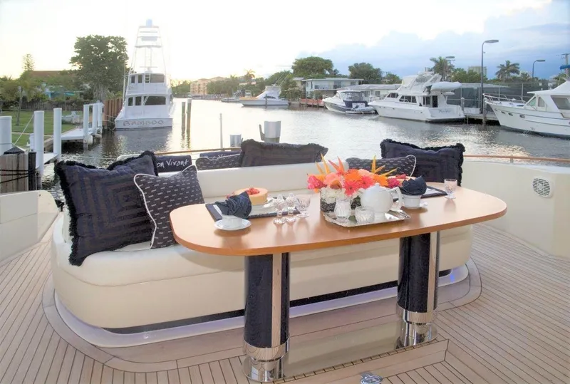 Slide: The Image of Luxury dining setup on a 2004 Riva Splendida yacht with marina view. - 4