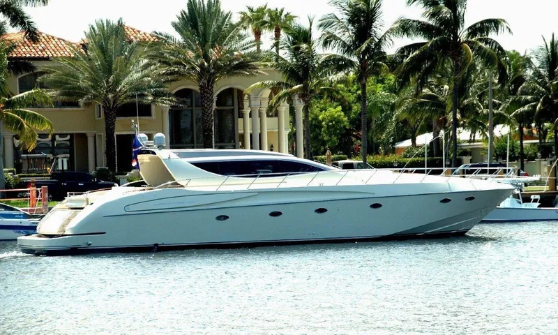 Slide: The Image of Luxury 2004 Riva Splendida yacht docked near waterfront mansion with palm trees. - 0