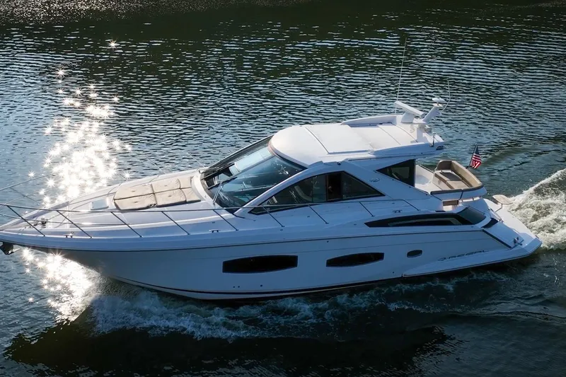 Slide: The Image of 2015 Regal 53 Sport Coupe yacht cruising on sparkling water. - 10