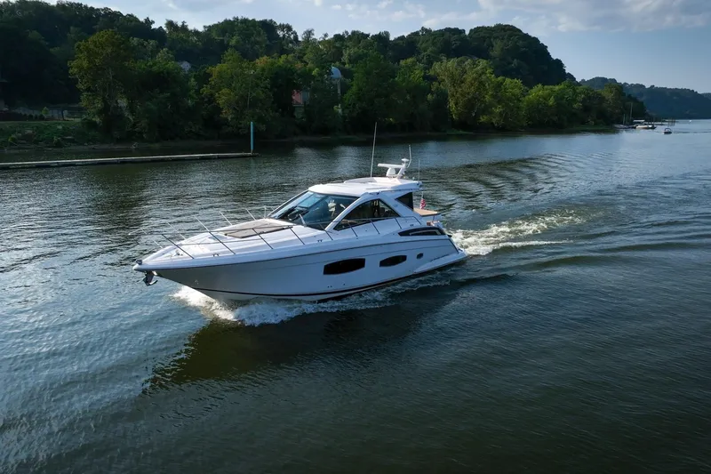 Slide: The Image of 2015 Regal 53 Sport Coupe cruising on a scenic river. - 19