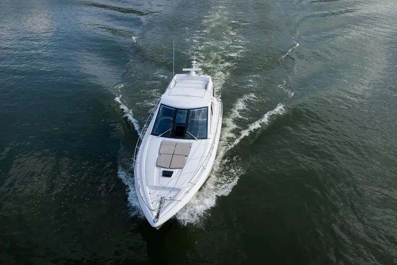 Slide: The Image of 2015 Regal 53 Sport Coupe cruising on open water, aerial view. - 23