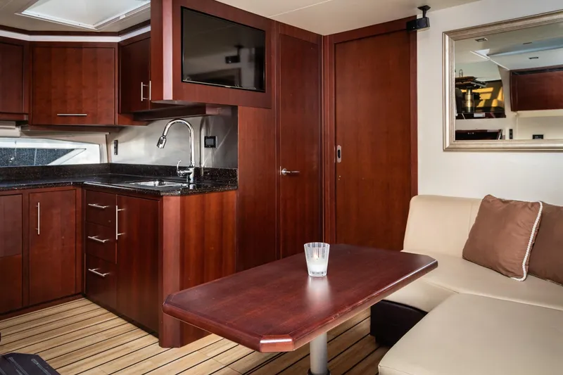 Slide: The Image of Luxurious interior of 2015 Regal 53 Sport Coupe yacht with modern kitchen and seating area. - 24