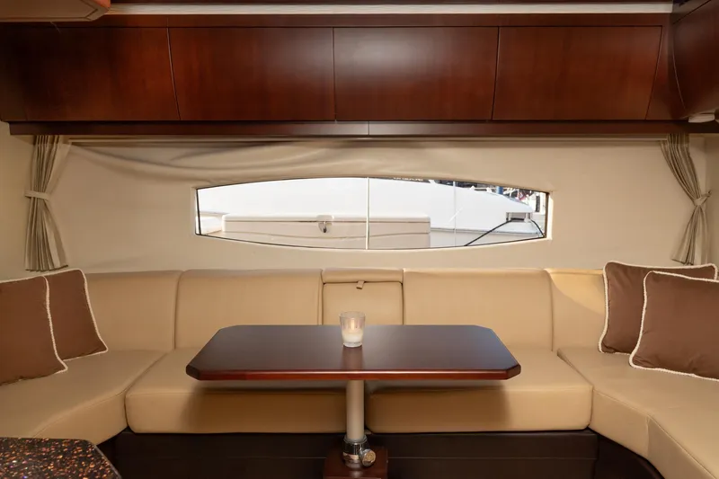 Slide: The Image of Luxurious interior of 2015 Regal 53 Sport Coupe with elegant seating and wooden table. - 25