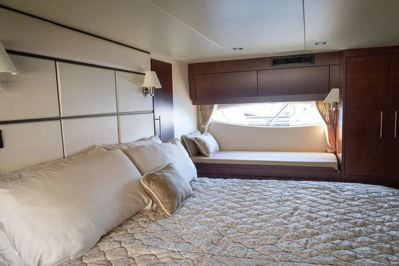 Slide: The Image of Luxurious bedroom interior of 2015 Regal 53 Sport Coupe yacht with elegant bedding and window seat. - 33