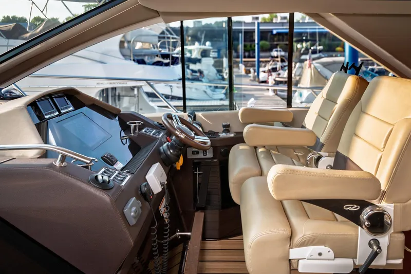 Slide: The Image of Luxurious interior of a 2015 Regal 53 Sport Coupe yacht with leather seating and modern controls. - 39