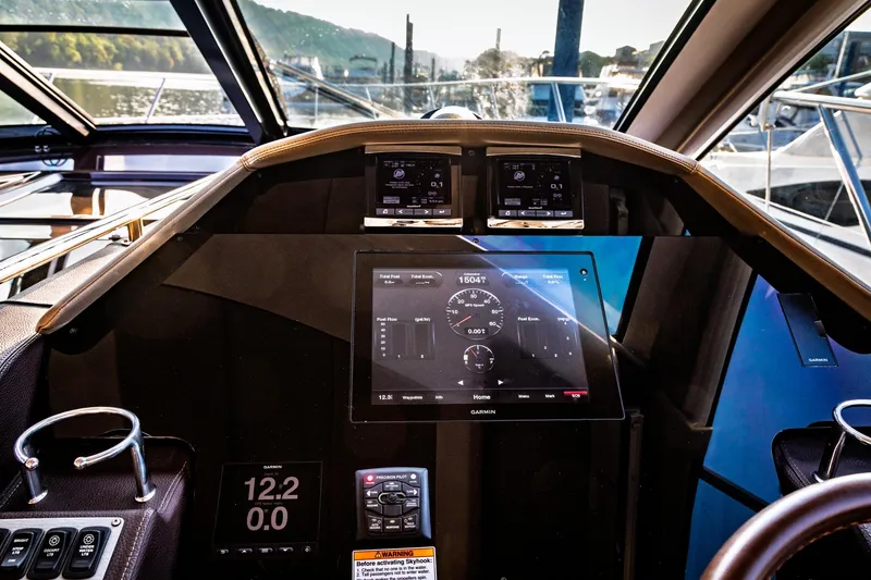 Slide: The Image of Cockpit of 2015 Regal 53 Sport Coupe with advanced navigation displays and controls. - 45