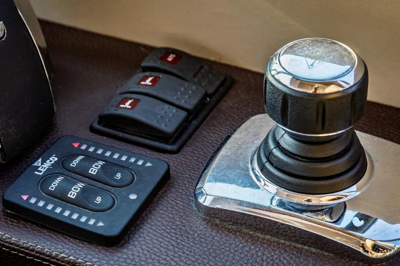 Slide: The Image of Control panel of a 2015 Regal 53 Sport Coupe with joystick and trim tab buttons. - 46