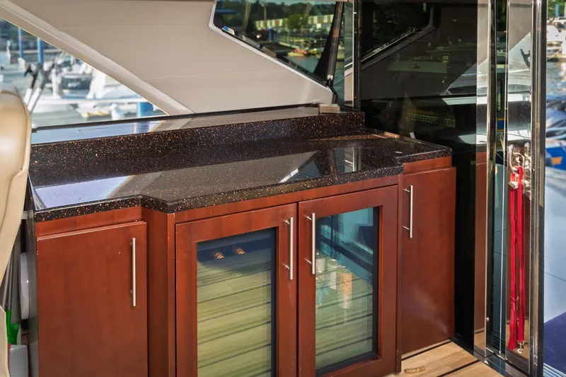 Slide: The Image of Luxurious interior of 2015 Regal 53 Sport Coupe with sleek countertop and wooden cabinetry. - 48