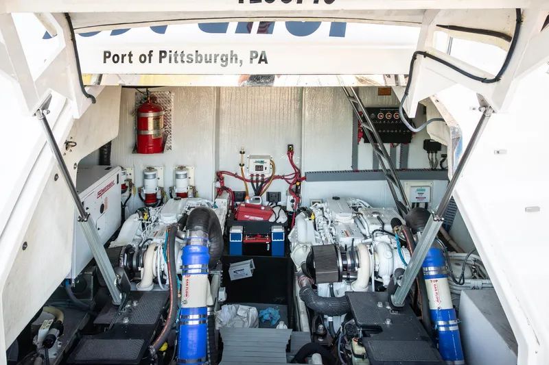 Slide: The Image of Engine room of 2015 Regal 53 Sport Coupe, featuring dual engines and fire safety equipment. - 57