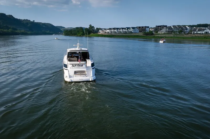 Slide: The Image of 2015 Regal 53 Sport Coupe cruising on a scenic river with houses in the background. - 6