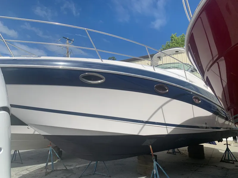 The Image of 2007 Four Winns 318 Vista boat on stands under a clear blue sky. - 0