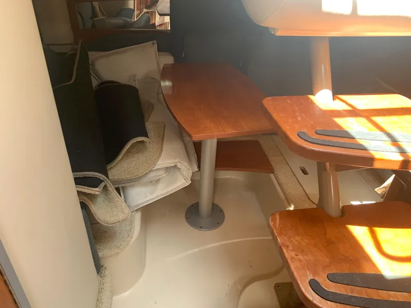Slide: The Image of Interior cabin of a 2007 Four Winns 318 Vista boat with wooden table and seating. - 11