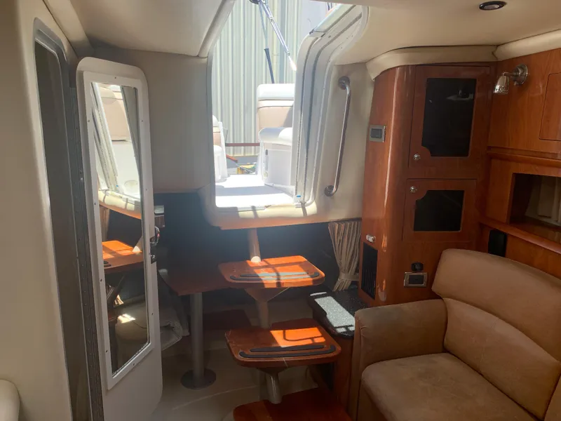 Slide: The Image of Interior of 2007 Four Winns 318 Vista boat with wooden cabinetry and seating. - 16