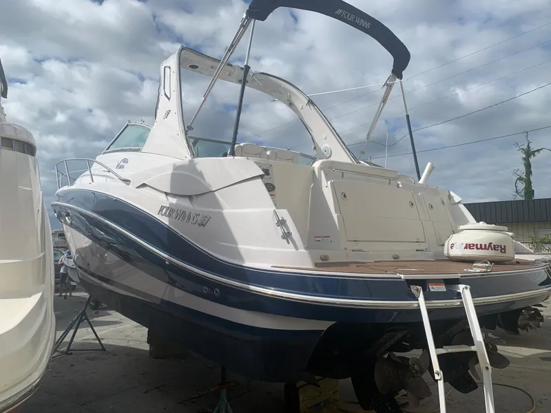 Slide: The Image of 2007 Four Winns 318 Vista boat on dry dock, rear view. - 2
