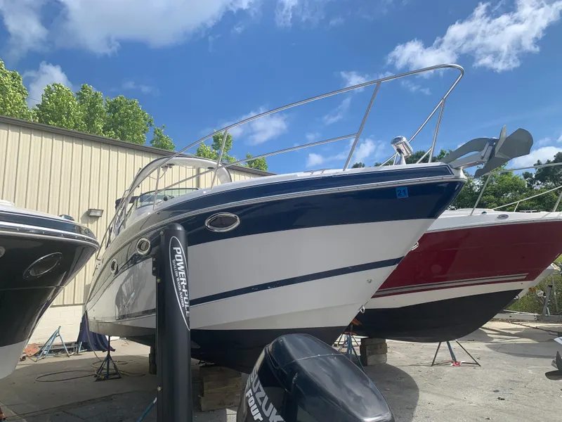 Slide: The Image of 2007 Four Winns 318 Vista boat in a marina, blue and white hull. - 3