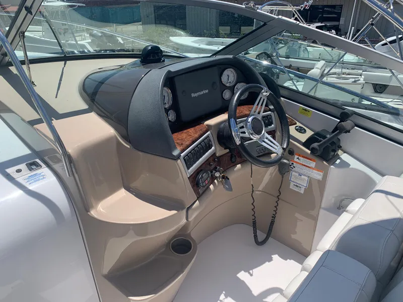 Slide: The Image of 2007 Four Winns 318 Vista boat cockpit with steering wheel and control panel. - 7
