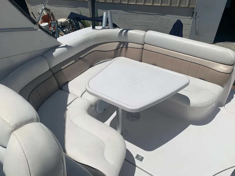 Slide: The Image of 2007 Four Winns 318 Vista boat with white and beige seating area and table. - 9