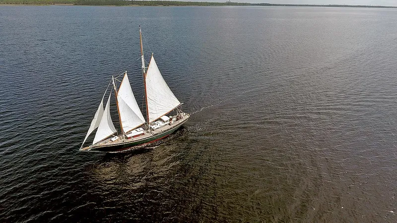 The Image of Aerial view of 1979 Custom Van Dyne Schooner sailing on calm waters. - 0